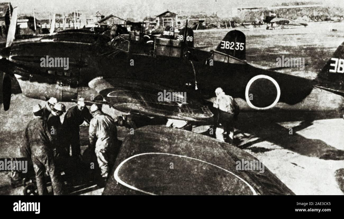 Technical staff near Japanese Yokosuka D4Y Suisei dive bombers. In the allied army, Yokosuka D4Y Suisei was codenamed “Judy.” Stock Photo
