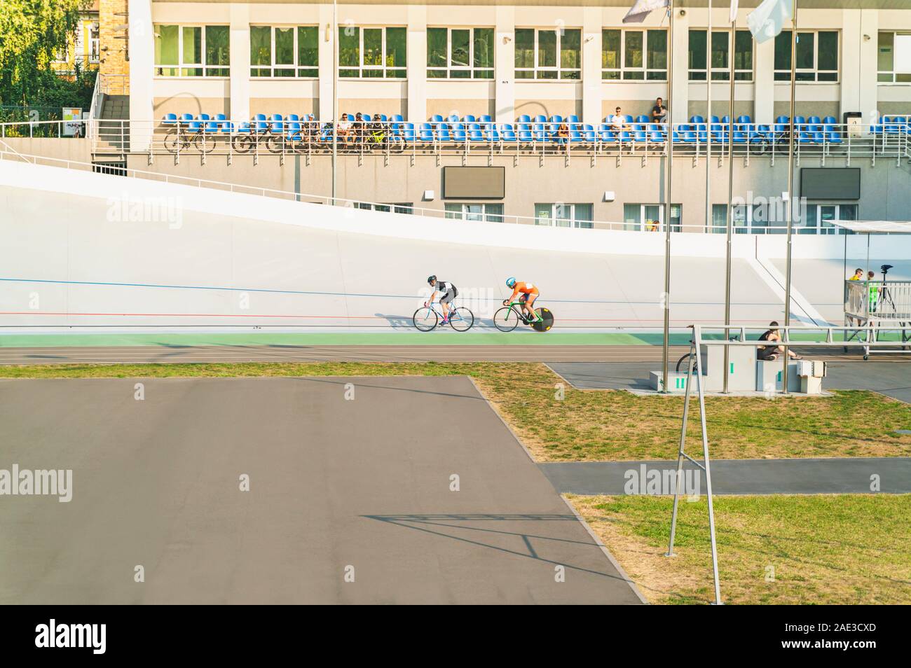 Cycling competition on the stadium in summer. Cyclers running bicycles at high speed. Horizontal image. Stock Photo