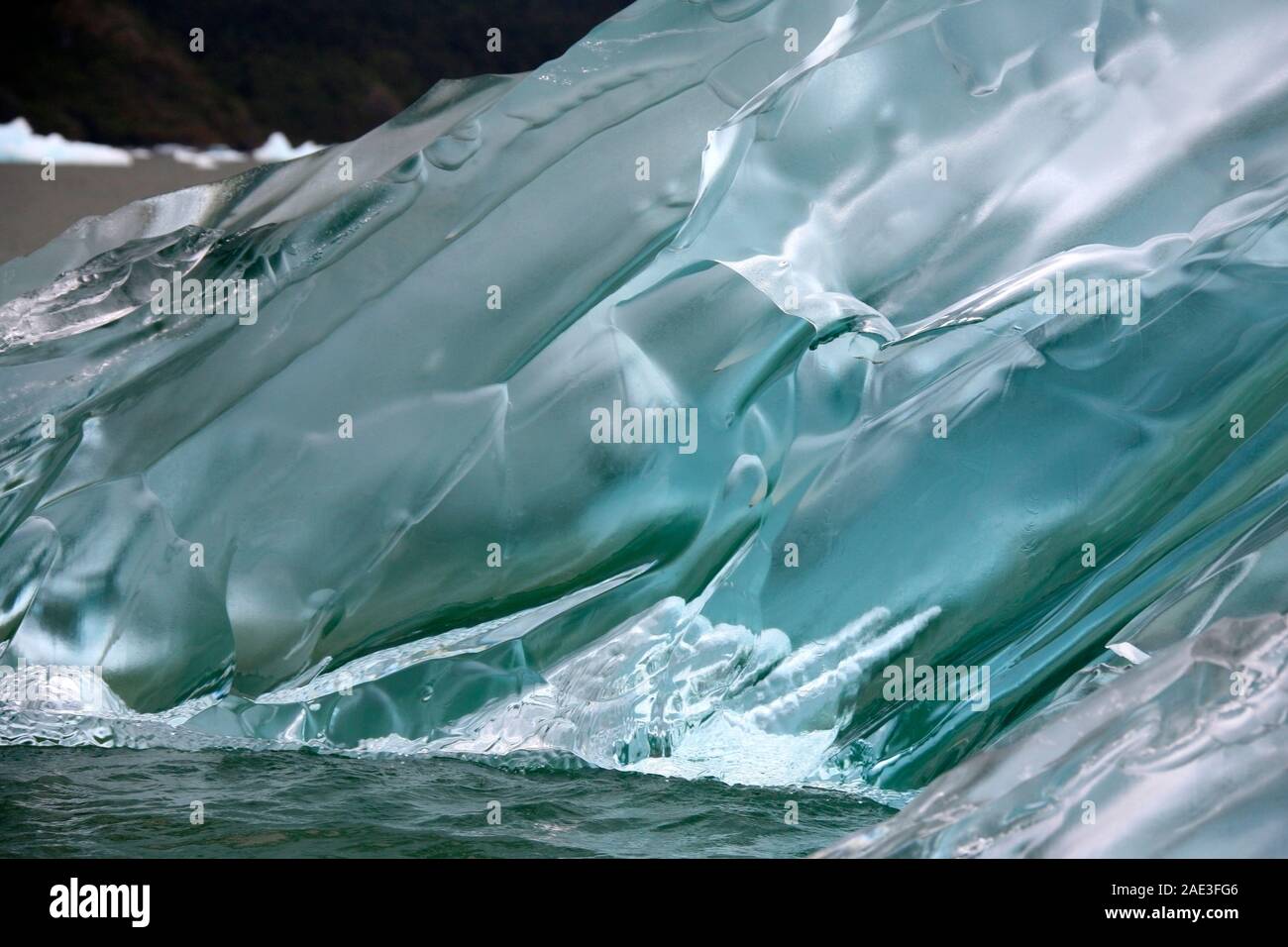 Green Amorphic Ice - formed deep within a glacier where the immense pressure has made the ice super dense, changing its refractive index so that light Stock Photo