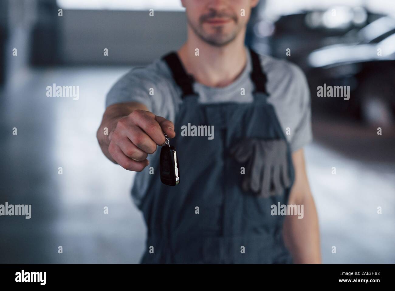 Hand of mechanic with keys. Your car is on the way again. Job well done Stock Photo