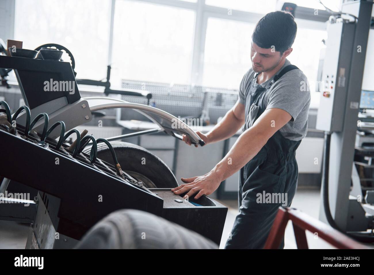Waiting for process is done. Young man works with wheel's disks at the ...