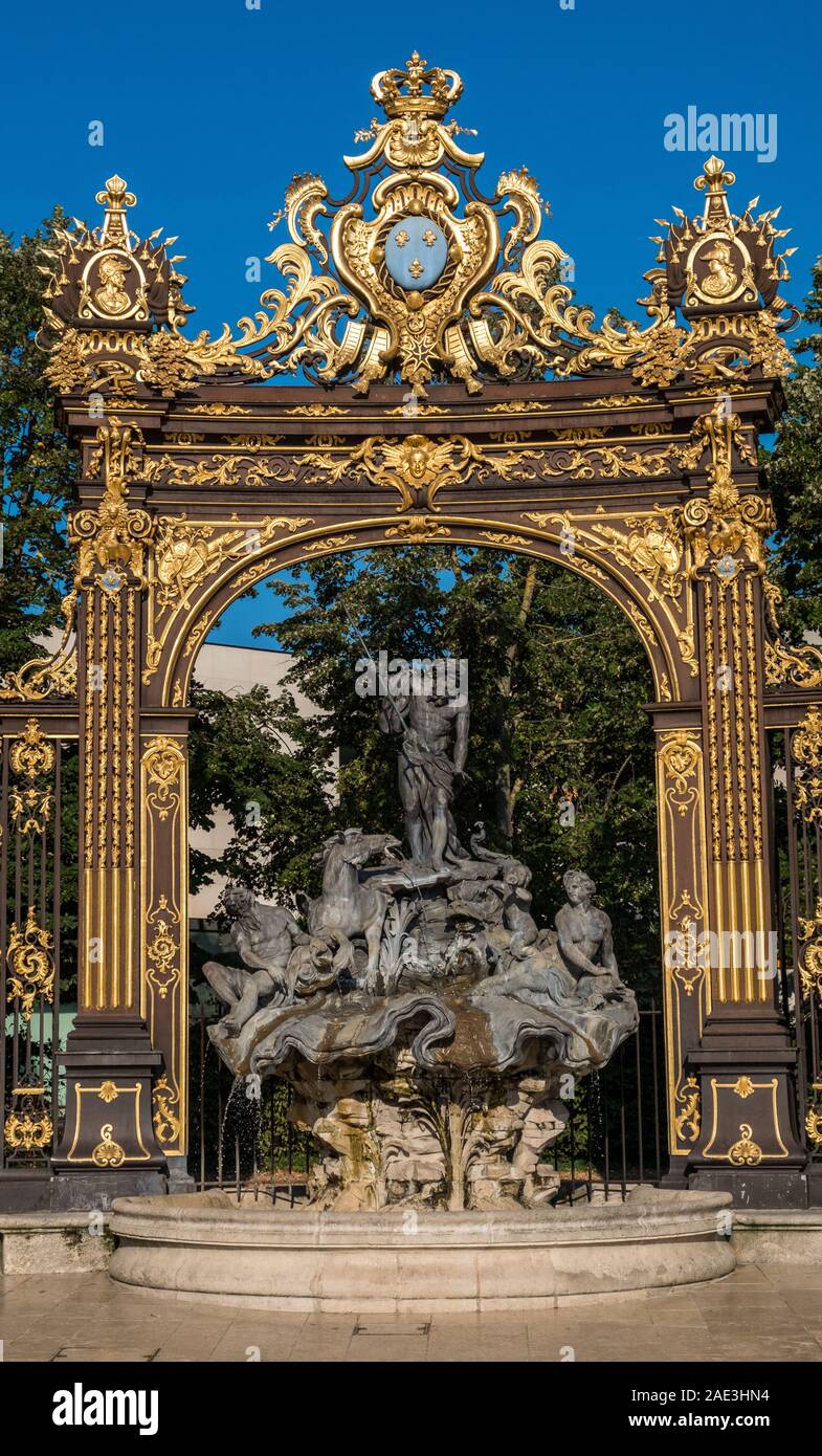 Nancy, France - August 31, 2019: Golden gate to the Place Stanislas square and Neptune Fountain, Nancy, Lorraine, France. A UNESCO World Heritage Site Stock Photo