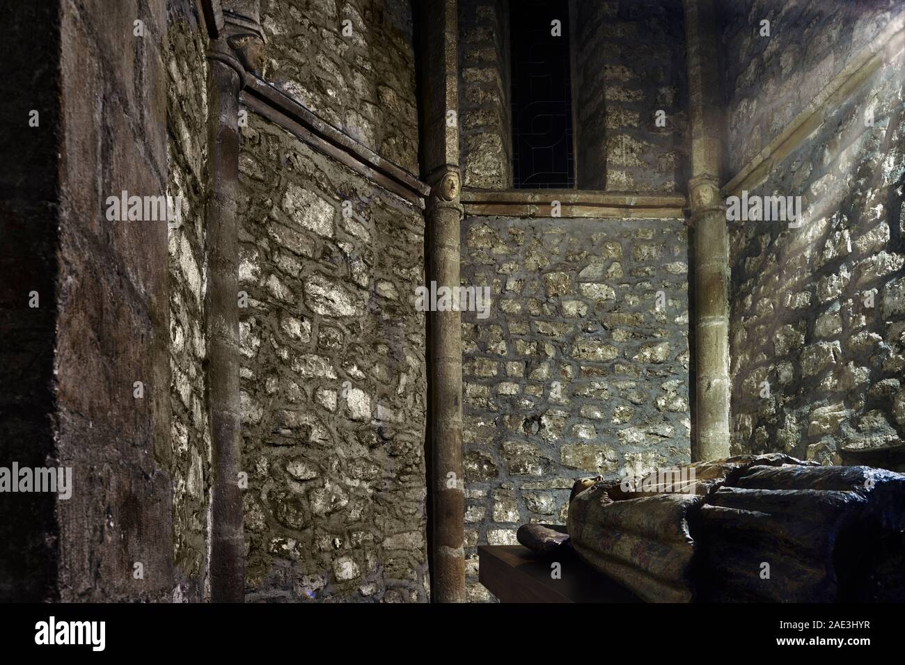 Abside of the Gospel in the monastery of Santo Toribio de Liebana with its recumbent wooden statue and capitals of human heads, Cantabria, Spain Stock Photo