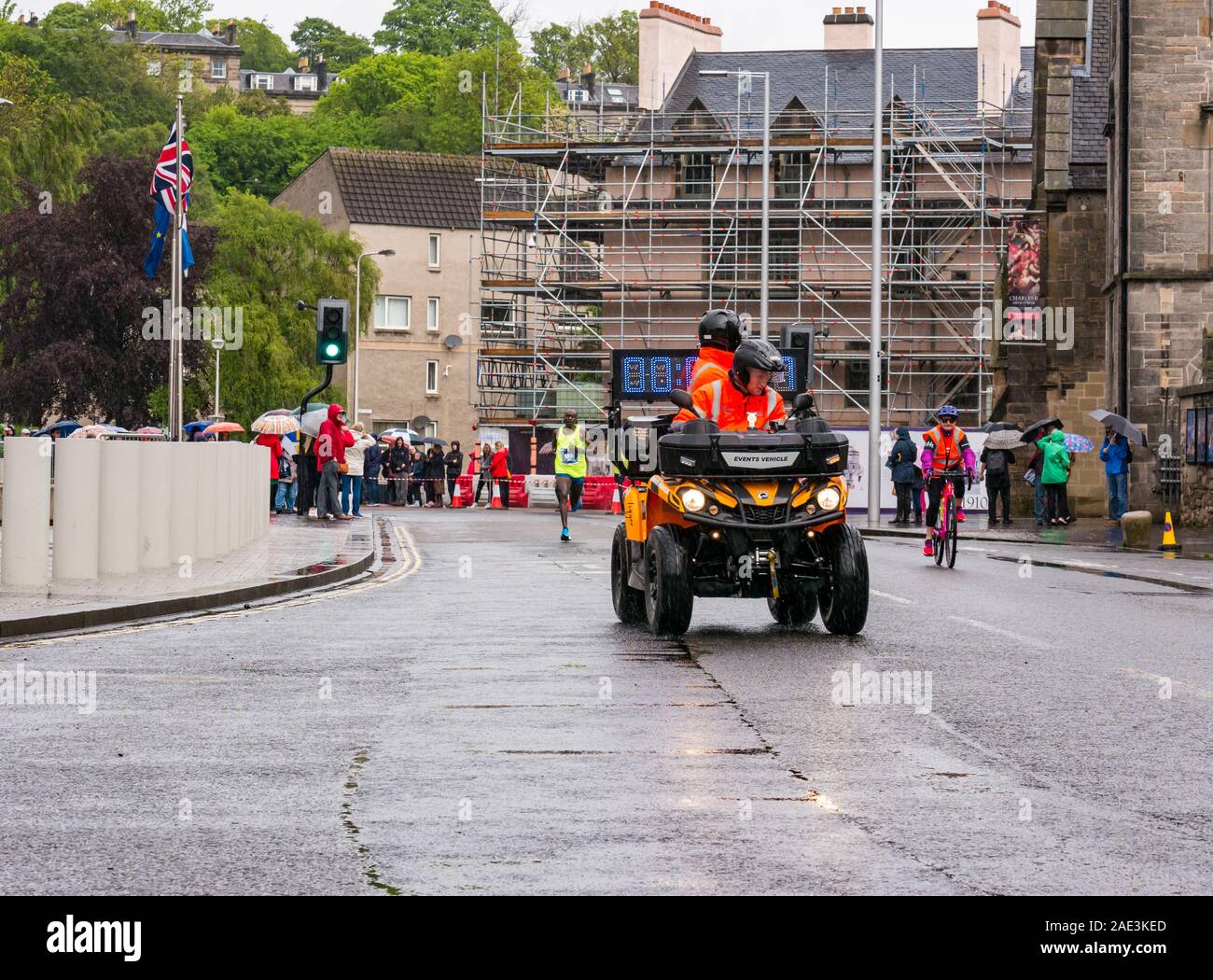 Edinburgh Marathon Festival 2019 at Holyrood Palace on a wet day with quad bike & leading runner Kenyan athlete Dan Tanui, Edinburgh, Scotland, Stock Photo