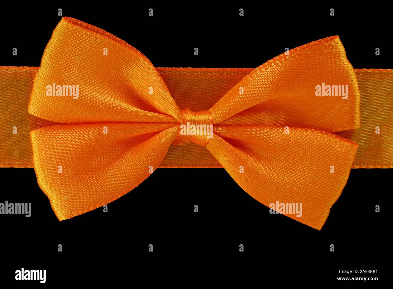 close up orange bow isolated on black background Stock Photo