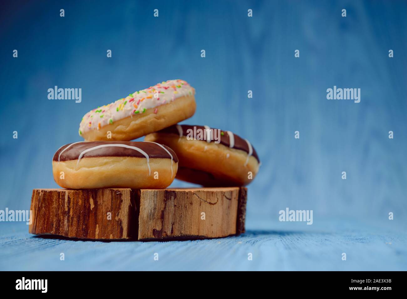 donuts lying on the table. blue background. Stock Photo