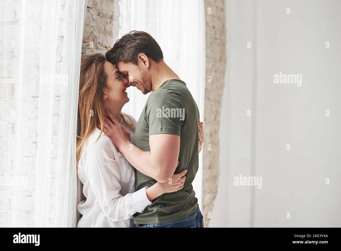 Attractive youth. Lovely couple kissing and enjoying each other near