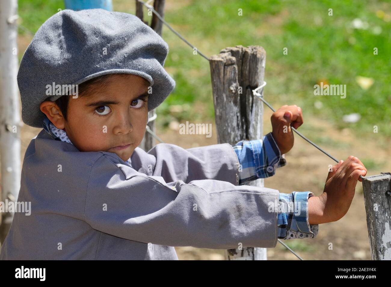 Boy with typical cap looks suspicious, Junin de los Andes, province Neuquen, Argentina Stock Photo