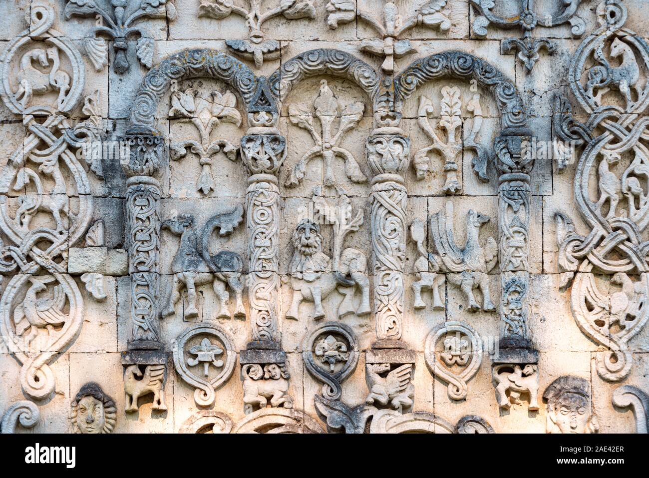 Big wall in church showing fictional characters. Primitive stone carving. Beautiful architecture of religious place. Tourist destination. Stock Photo