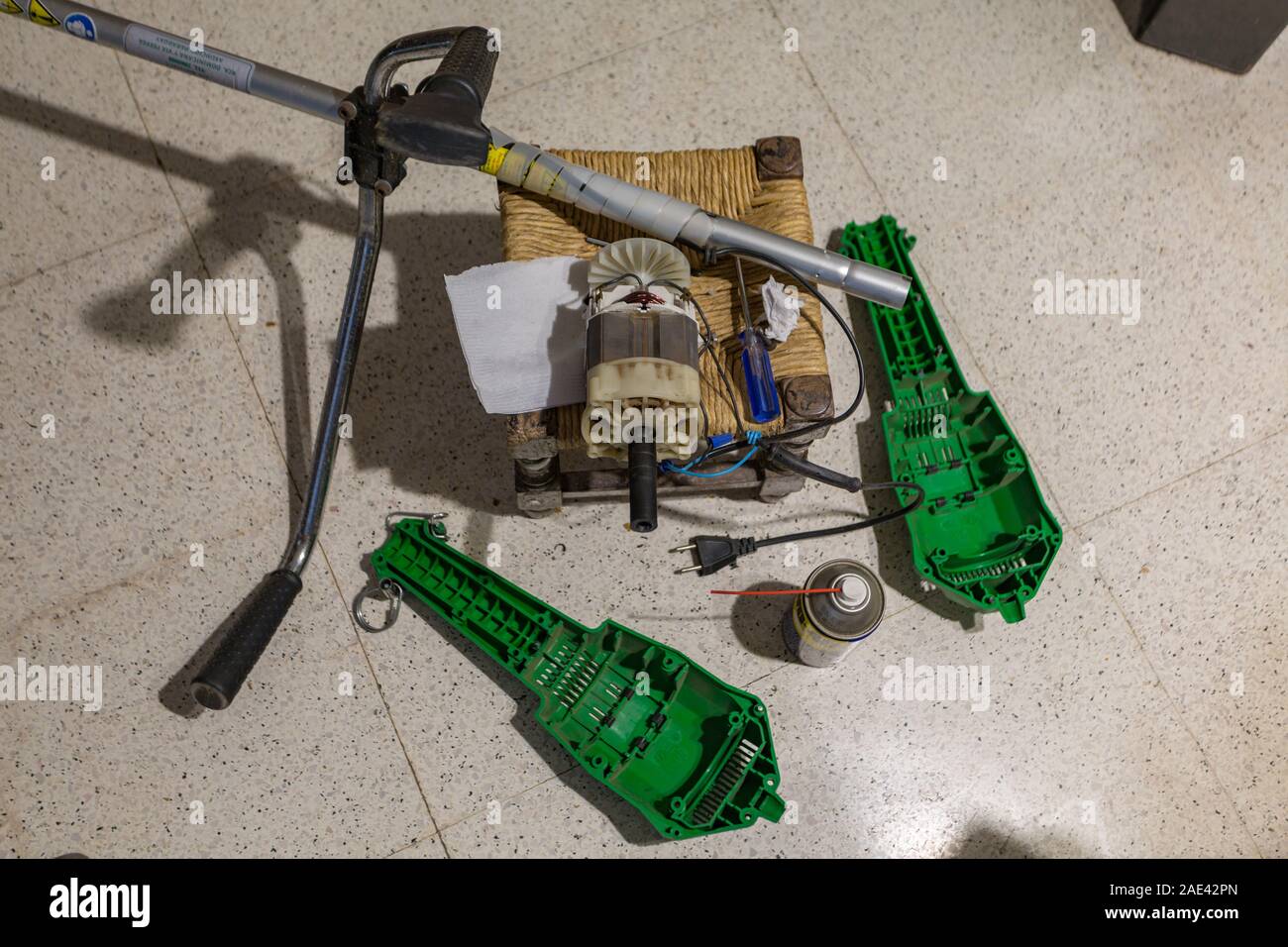 Lawn edge string trimmer repair, disassembly, view of its interior electric  motor Stock Photo - Alamy