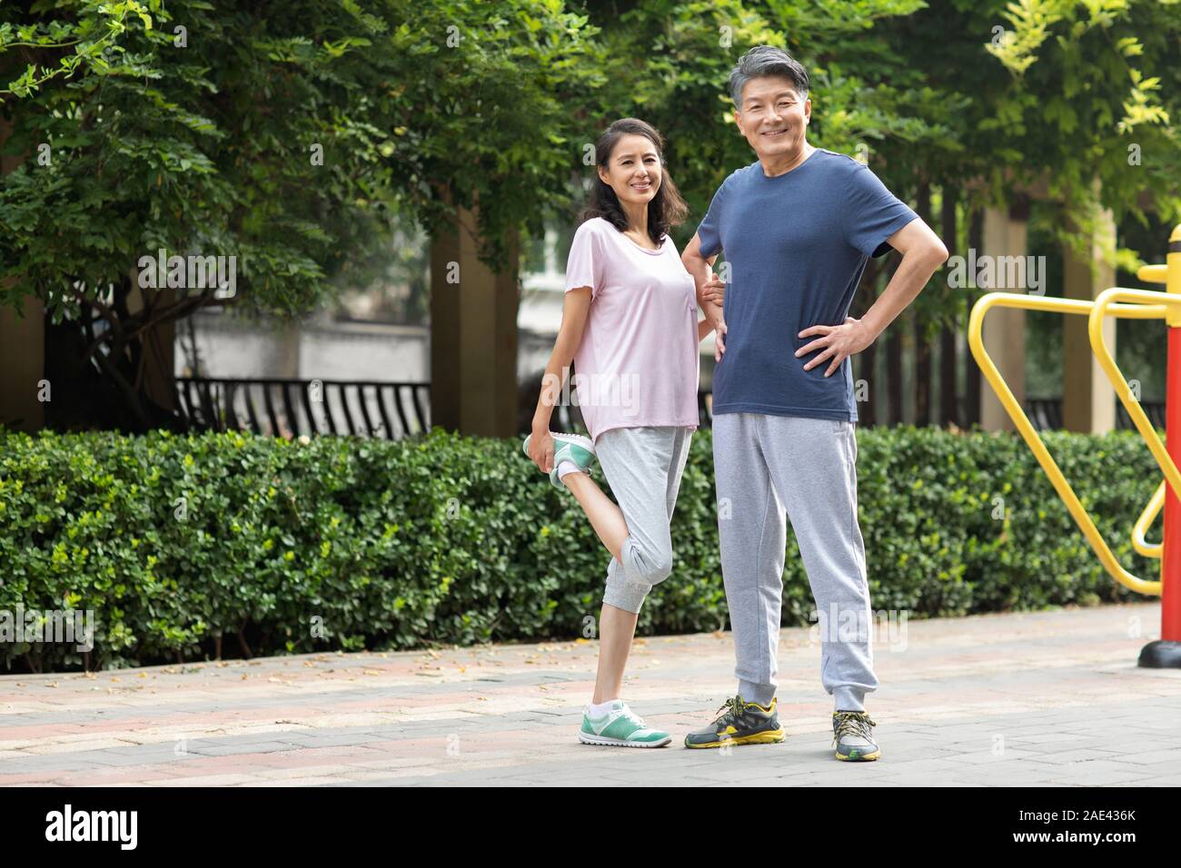 Happy mature couple exercising in park Stock Photo - Alamy