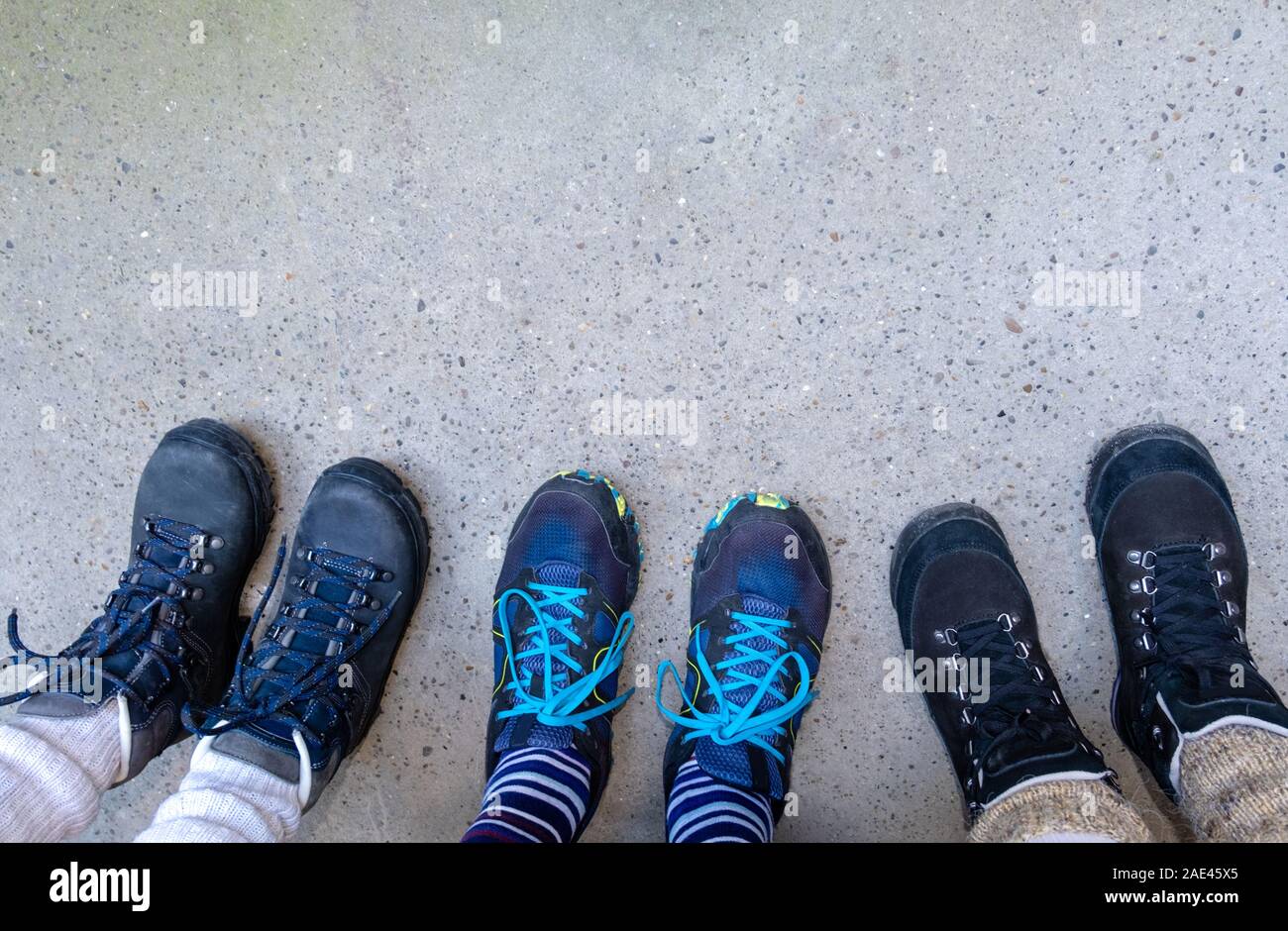 Three pair of legs in boots for hiking 