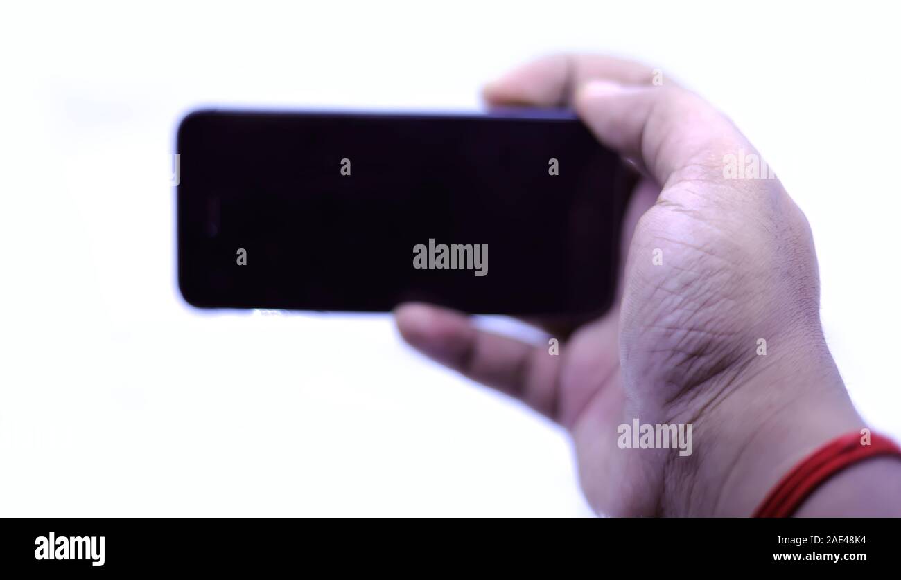 Man hand holding black smartphone isolated on white background ...