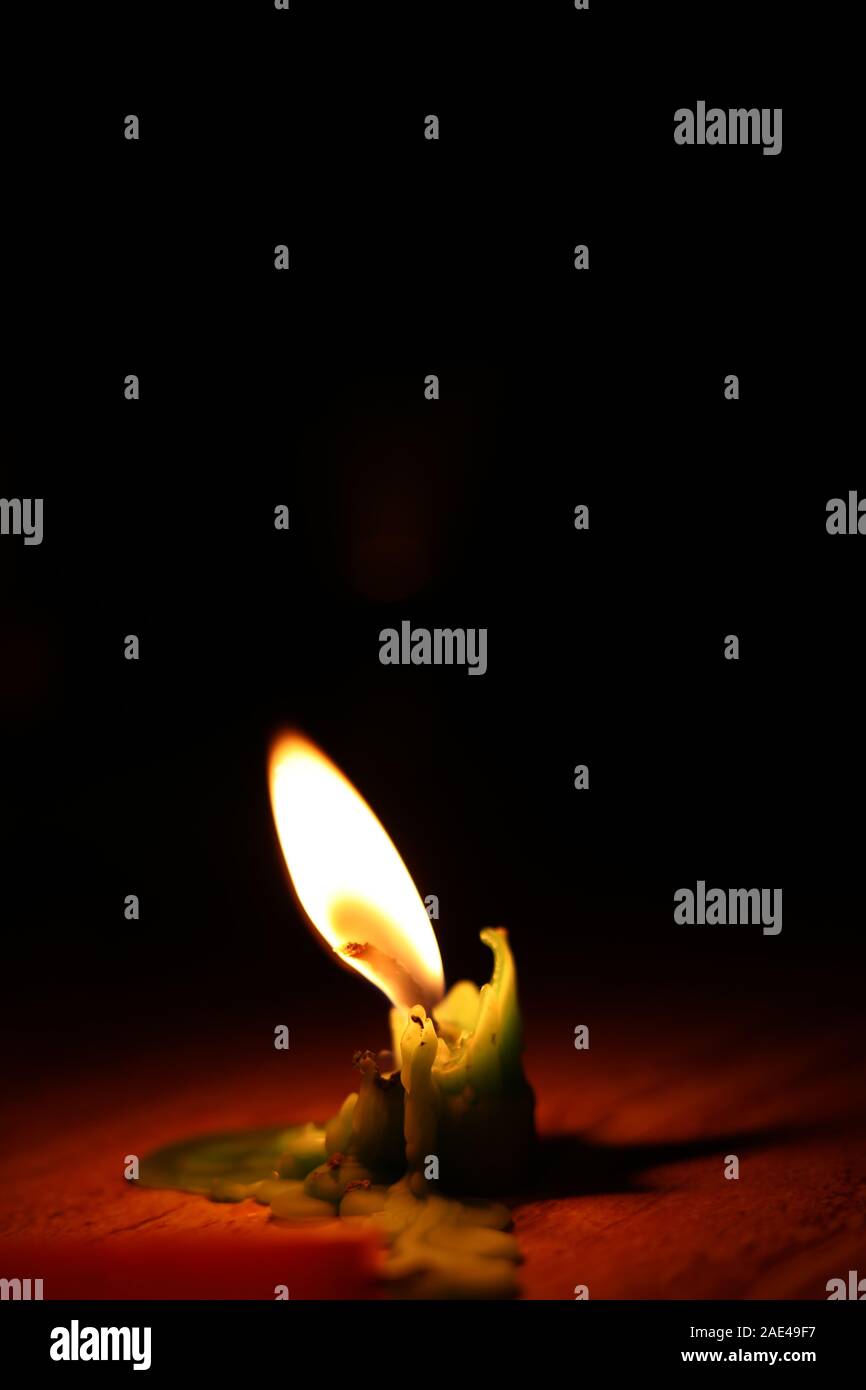 One candle flame at night closeup - isolated Stock Photo