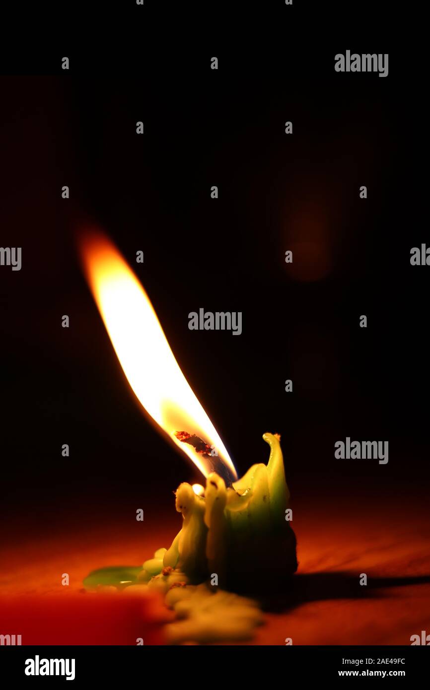 One candle flame at night closeup - isolated Stock Photo