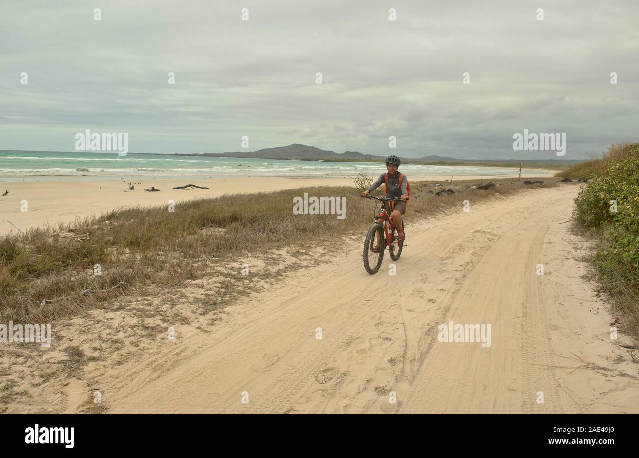 Bicycling along an empty beach, Isla Isabela, Galapagos Islands, Ecuador Stock Photo