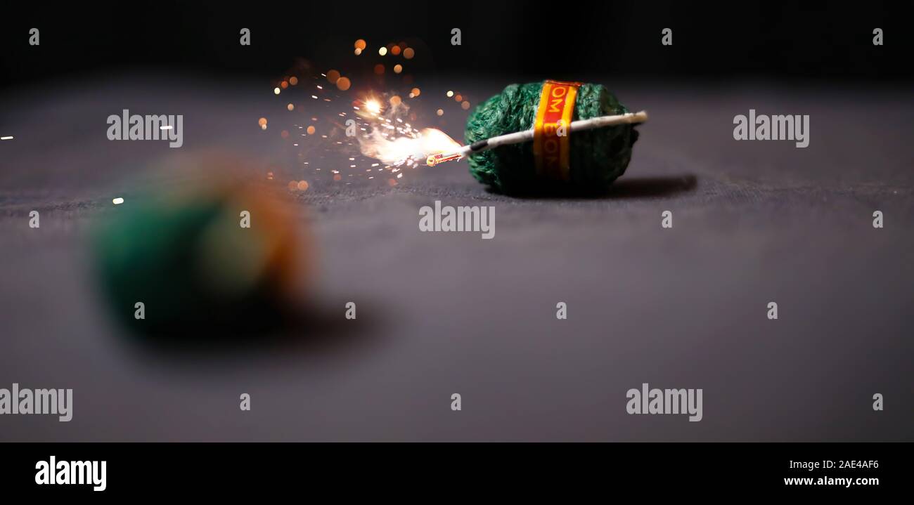 Diwali fire bomb cracker on black backgrounds Stock Photo