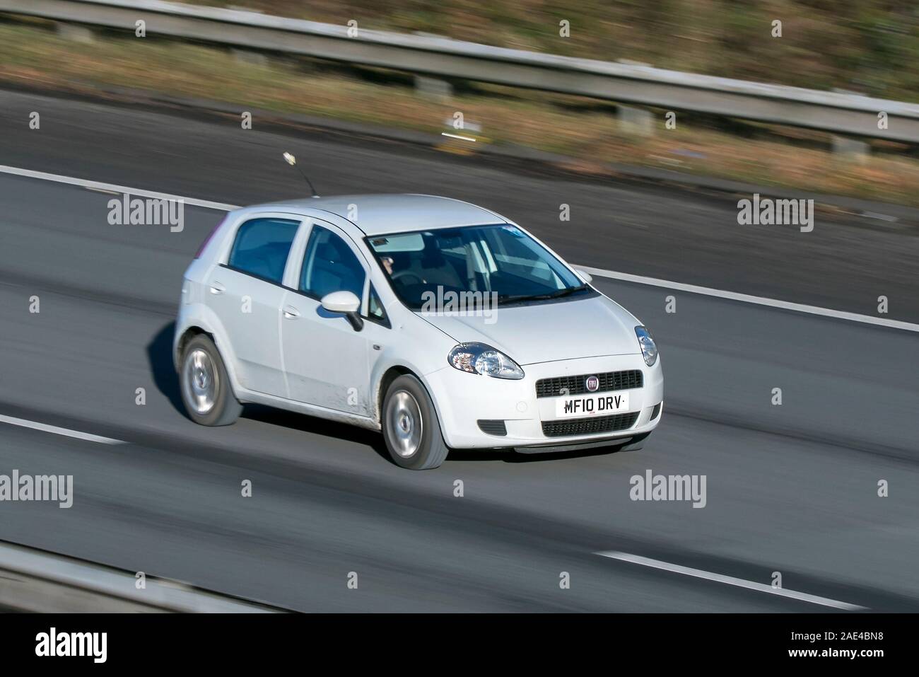 Blurred moving car FIAT Grande Punto Sound traveling at speed on the M61 motorway Slow camera shutter speed vehicle movement Stock Photo
