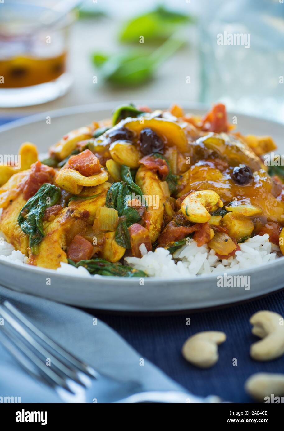 Moroccan chicken and vegetables over rice with chutney Stock Photo Alamy