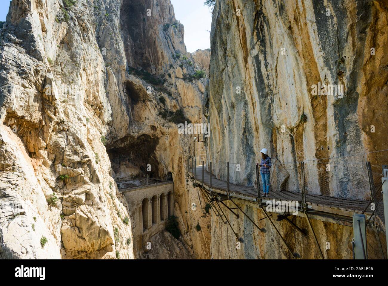 Woman watching the panoramic view of the Desfiladero de los Gaitanes from one of the walkways that make up the Caminito de Rey, Natural Site of Desfil Stock Photo