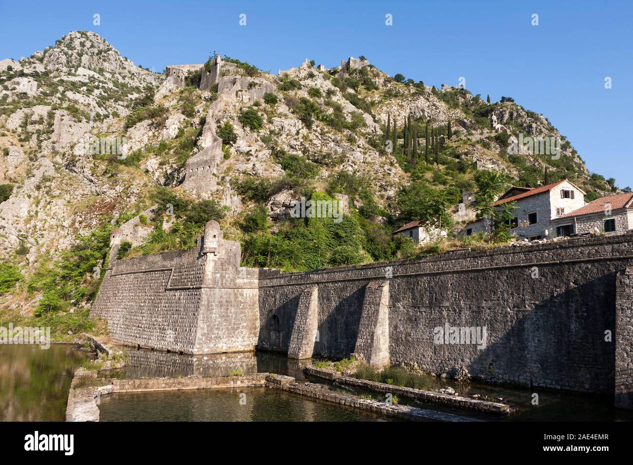 The ramparts surrounding the old town and the Fort of St. Ivan above:  Kotor, Montenegro Stock Photo