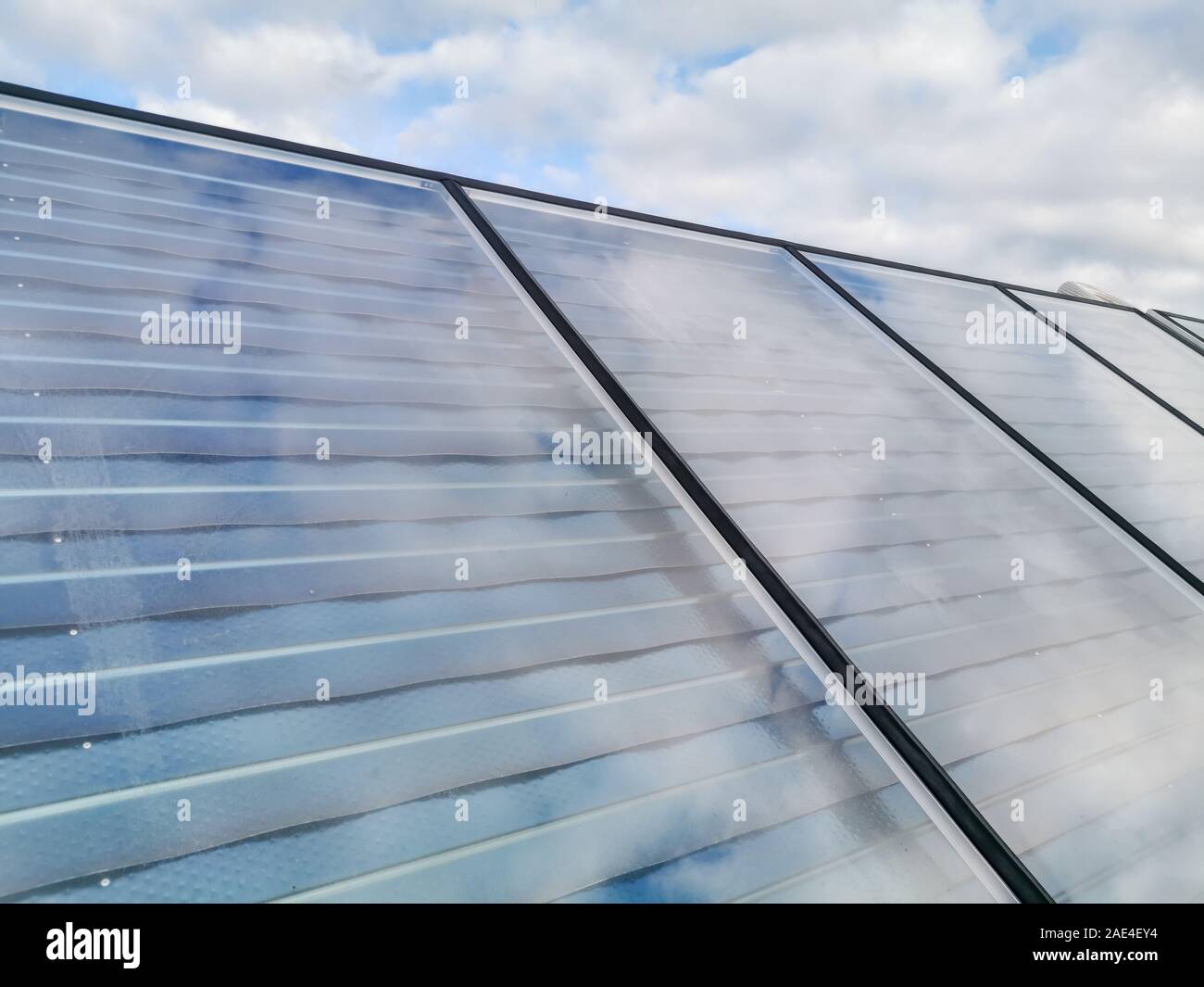 Field Photovoltaic solar production panels on a building roof Stock Photo