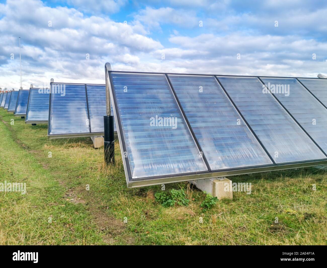Field Photovoltaic solar production panels on a building roof Stock Photo