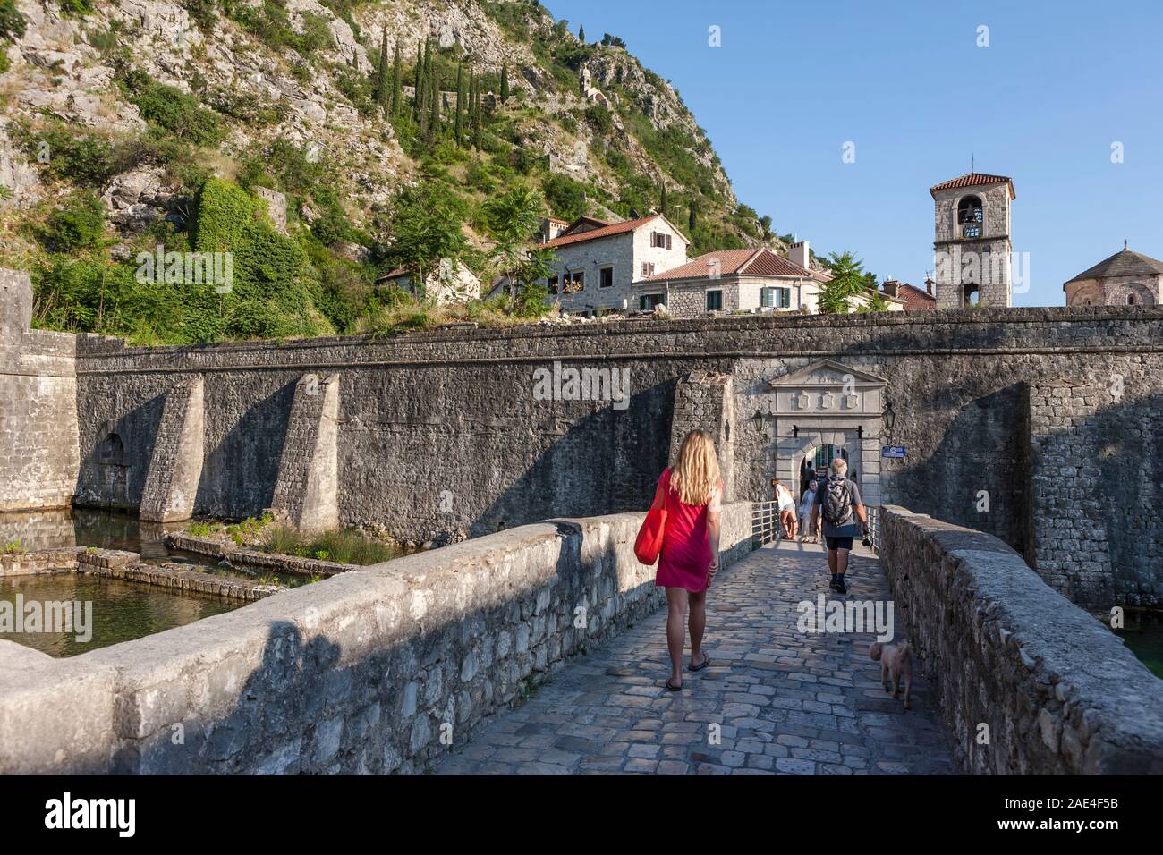 The bridge over the Škurda River to Vrata od Rijeke (North Gate) and ramparts surrounding the old town of Kotor, Montenegro Stock Photo