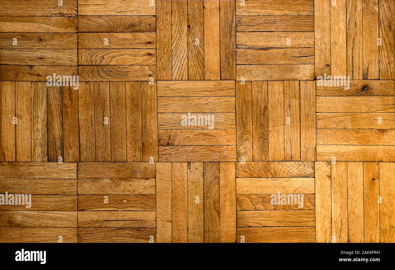 Fragment of old wooden parquet floor. Tileable background of an inlaid mosaique type parquet floor. Stock Photo