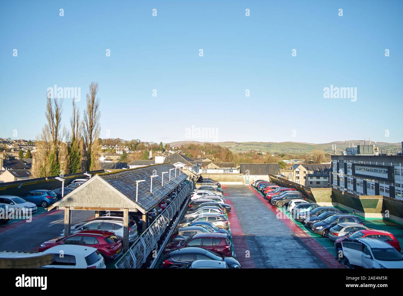 View across the top deck of a multi story car park showing hills beyond Stock Photo