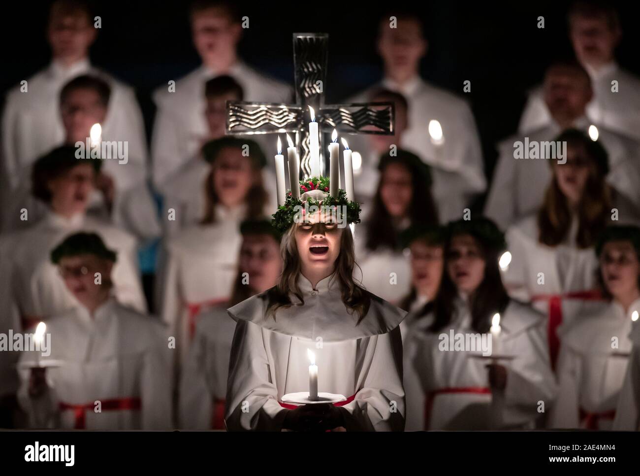 Matilda Bergstrom wearing a crown of candles symbolising St Lucy, leads a candlelit procession of the London Nordic Choir during the Sankta Lucia service at York Minster. Picture date: Friday December 6, 2019. The atmospheric Swedish service is a celebration of St Lucy, a Sicilian girl martyred for her Christian faith in the fourth century. The crown symbolises a halo, a red sash her martyrdom, and the service celebrates the bringing of light during the darkness of winter. Photo credit should read: Danny Lawson/PA Wire Stock Photo
