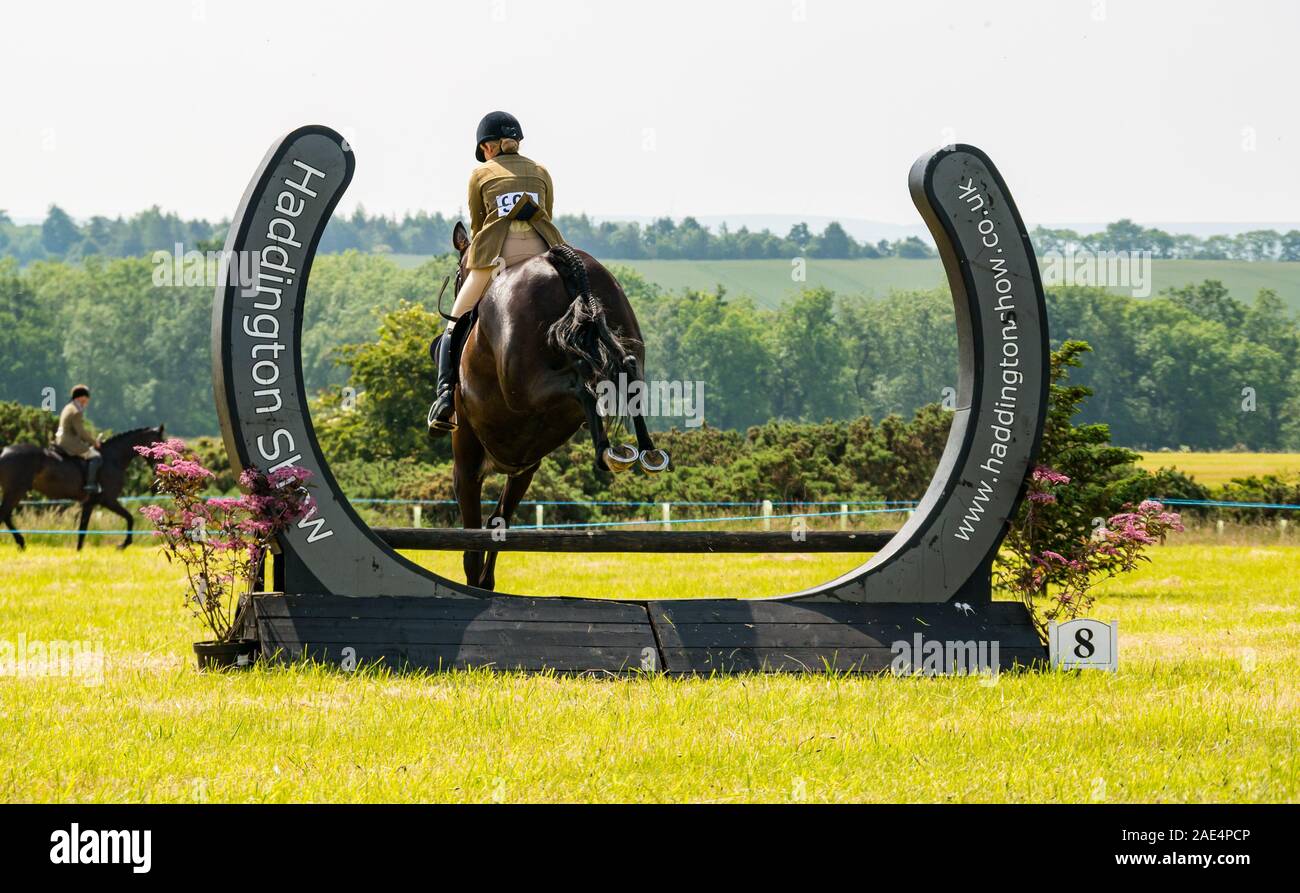 Wome riding horse at show jumping, Haddington Agricultural Show, East Lothian, Scotland, UK Stock Photo