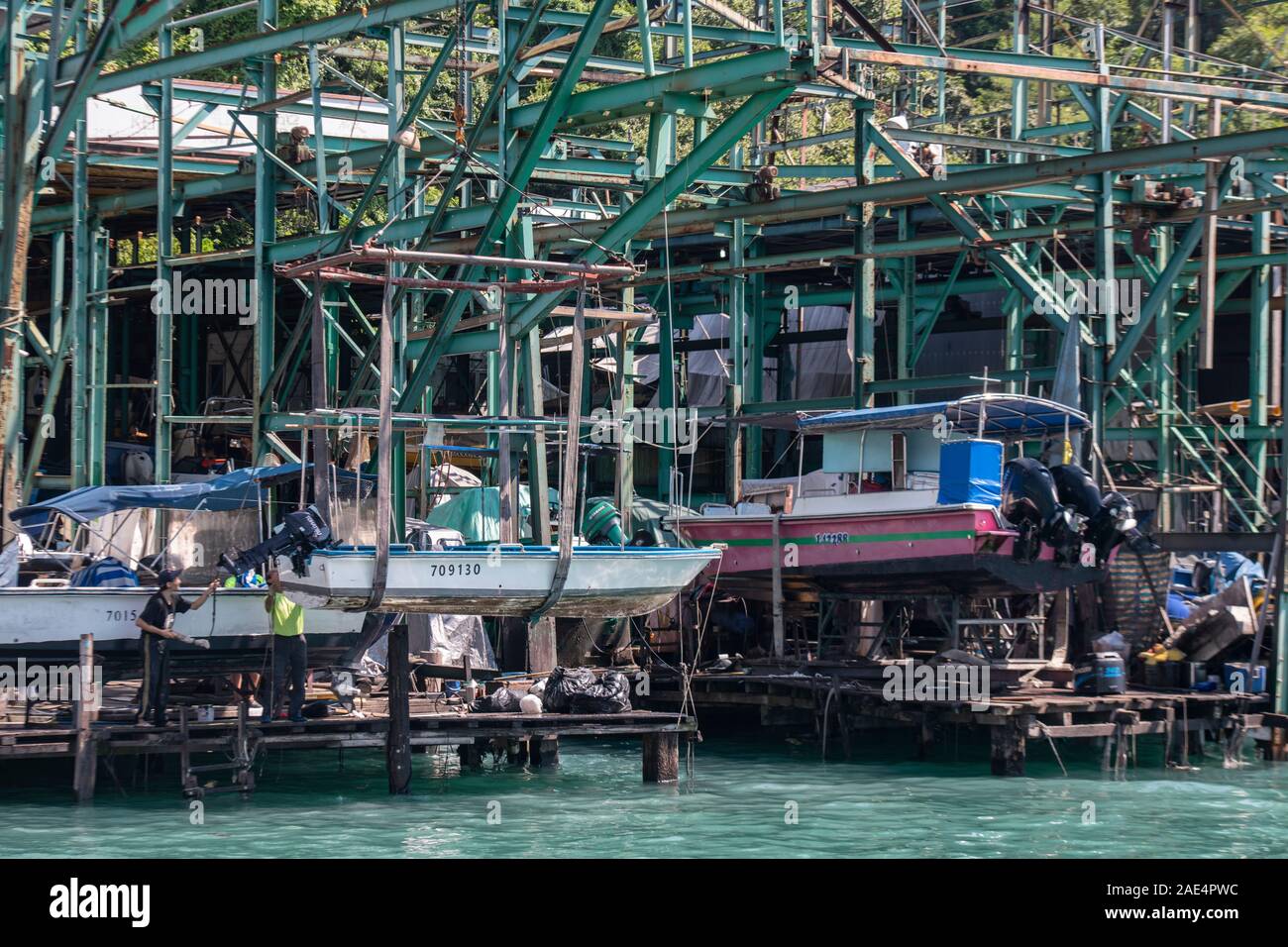 A shipyard repairs boats in dry dock in Hong Kong Island's Aberdeen Harbour Stock Photo