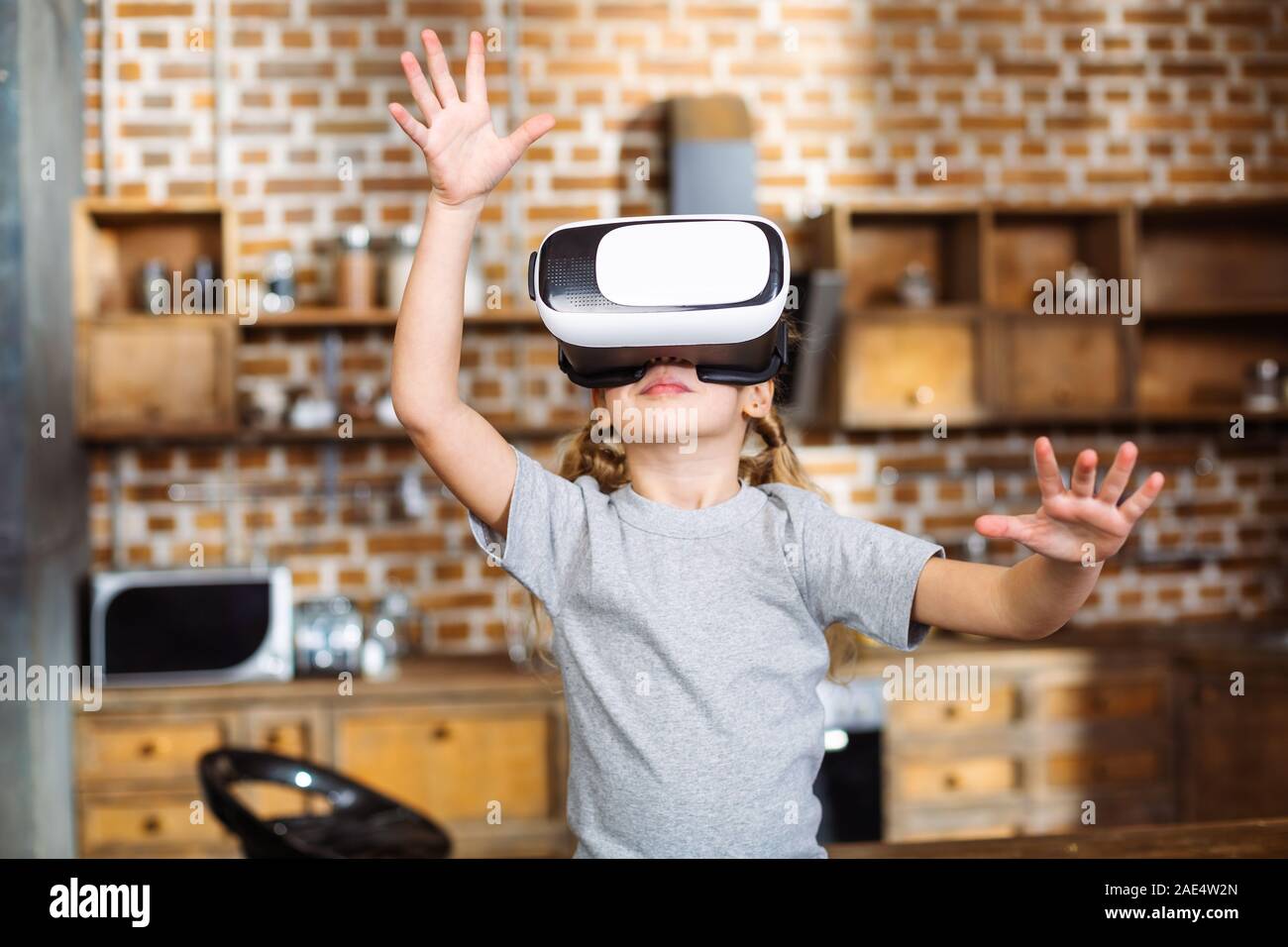 Positive little girl testing VR glasses Stock Photo