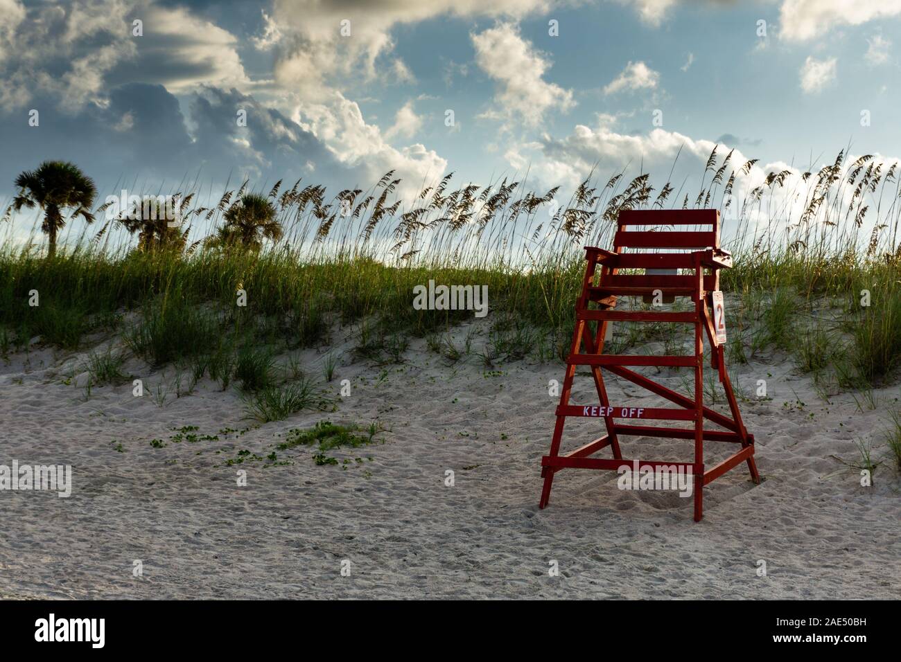 Life guard chair on the beach with sea oats and blue skies. Stock Photo