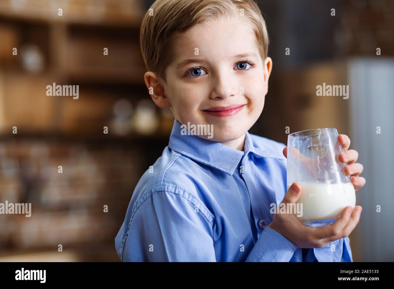 Portrait of smiling boy drinking milk Stock Photo