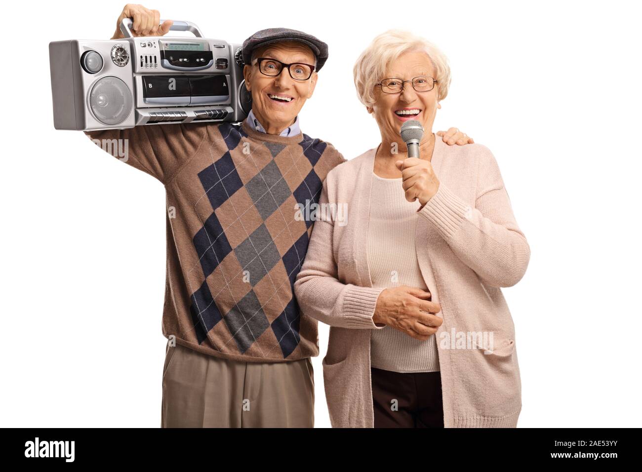 Elderly woman holding a microphone and an elderly man with a boombox radio isolated on white background Stock Photo