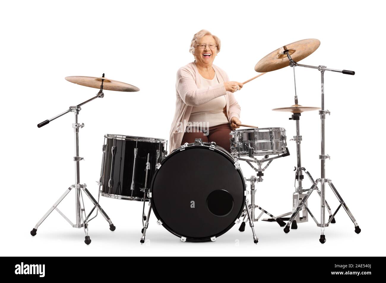 Elderly woman playing drums isolated on white background Stock Photo