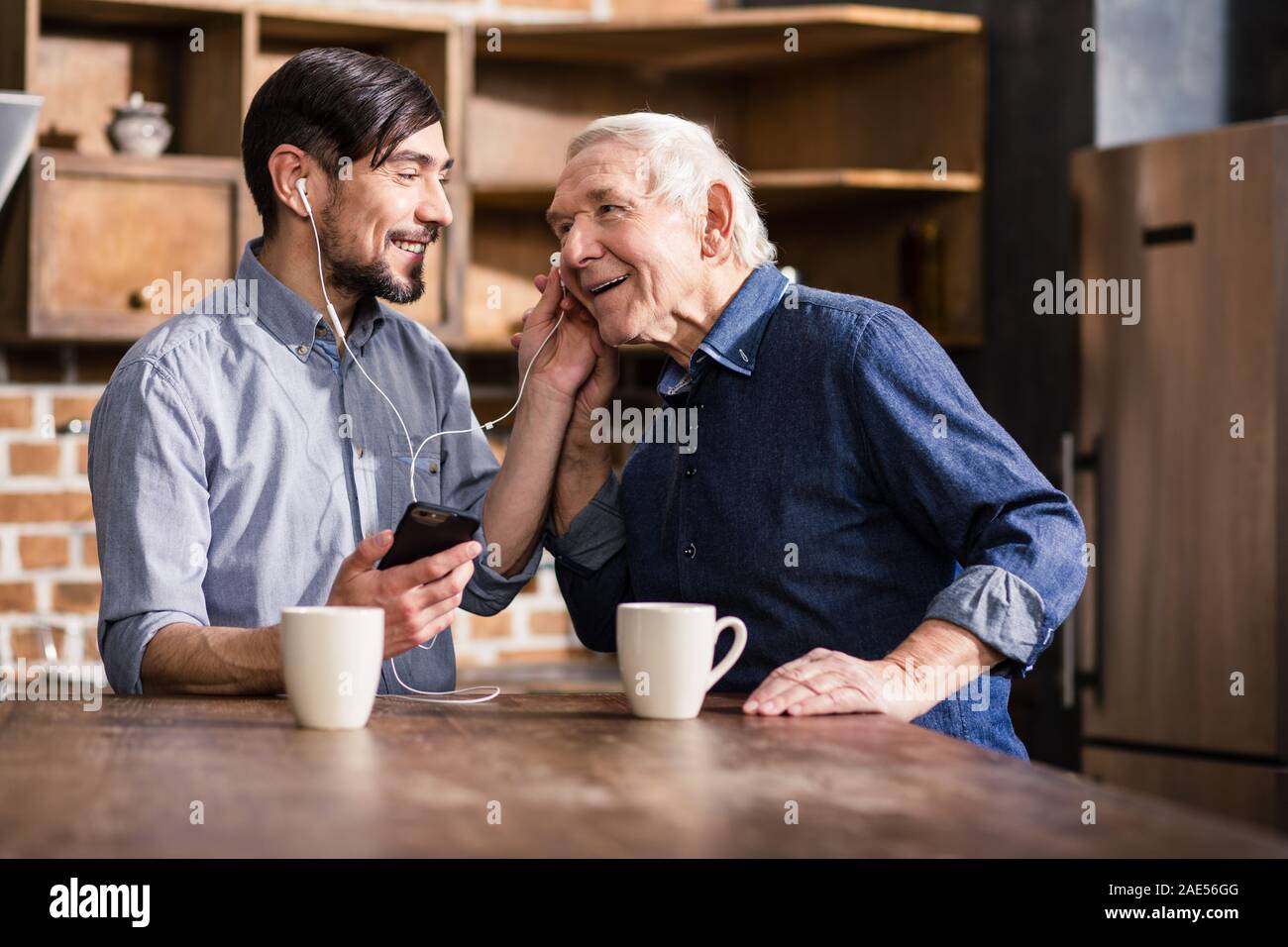 Aged smiling man talking on phone Stock Photo