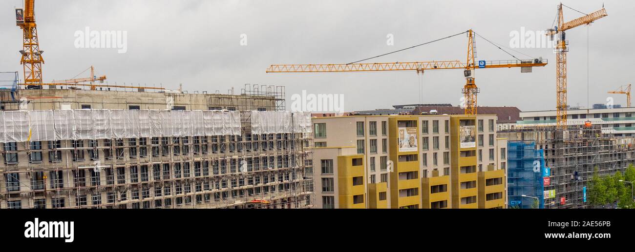 Building site for construction of apartment blocks and tower cranes