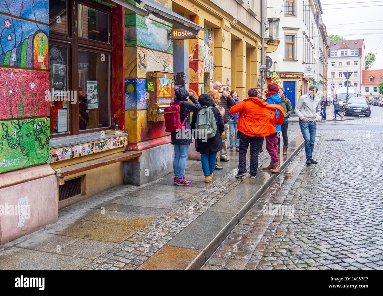 Tourists putting on wet weather clothes going on a guided walking tour of Neustadt Dresden Saxony Germany. Stock Photo