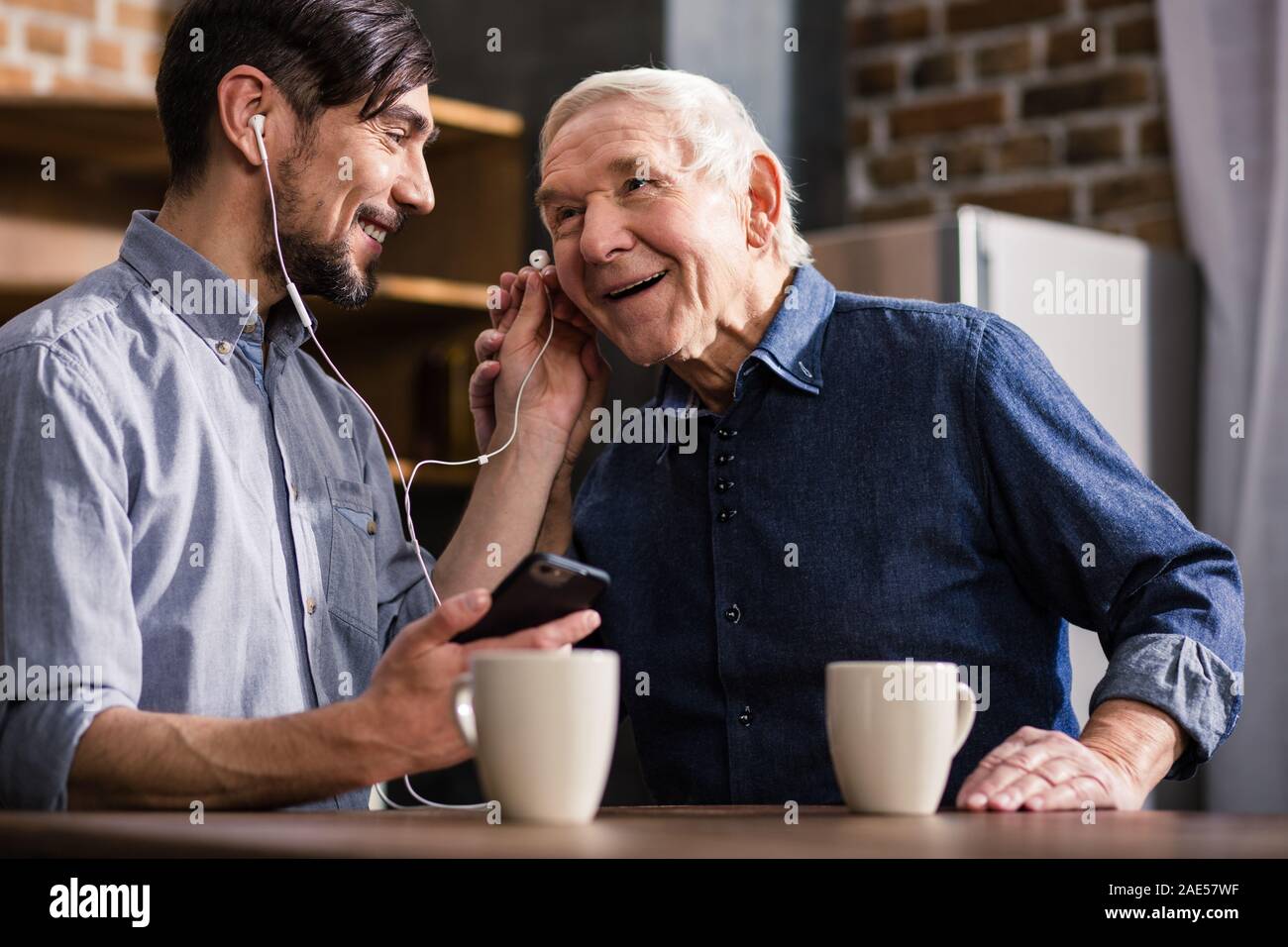 Joyful elderly man talking on smartphone Stock Photo