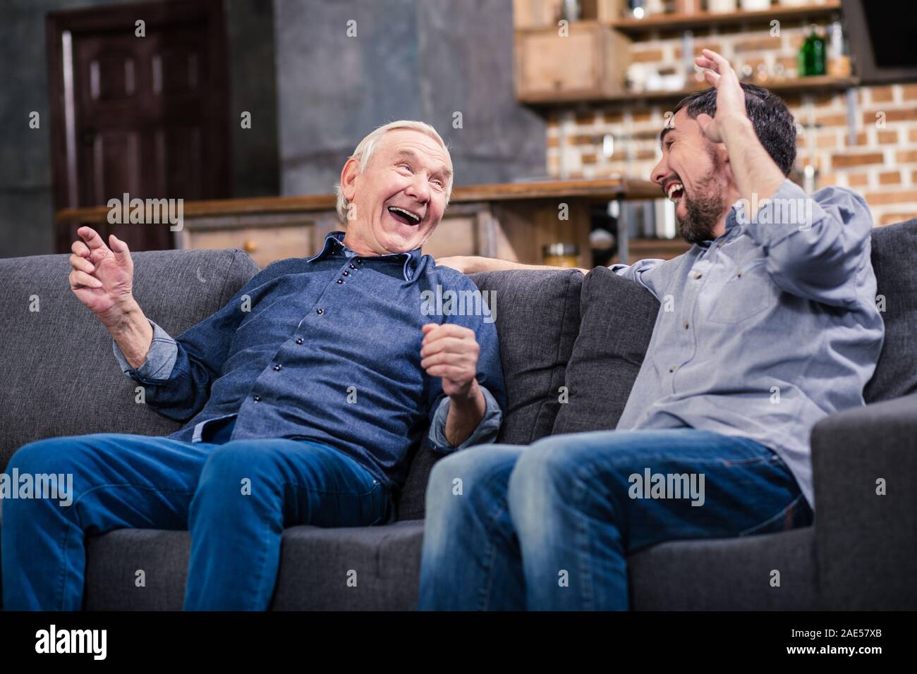 Joyful aged man and his son resting Stock Photo