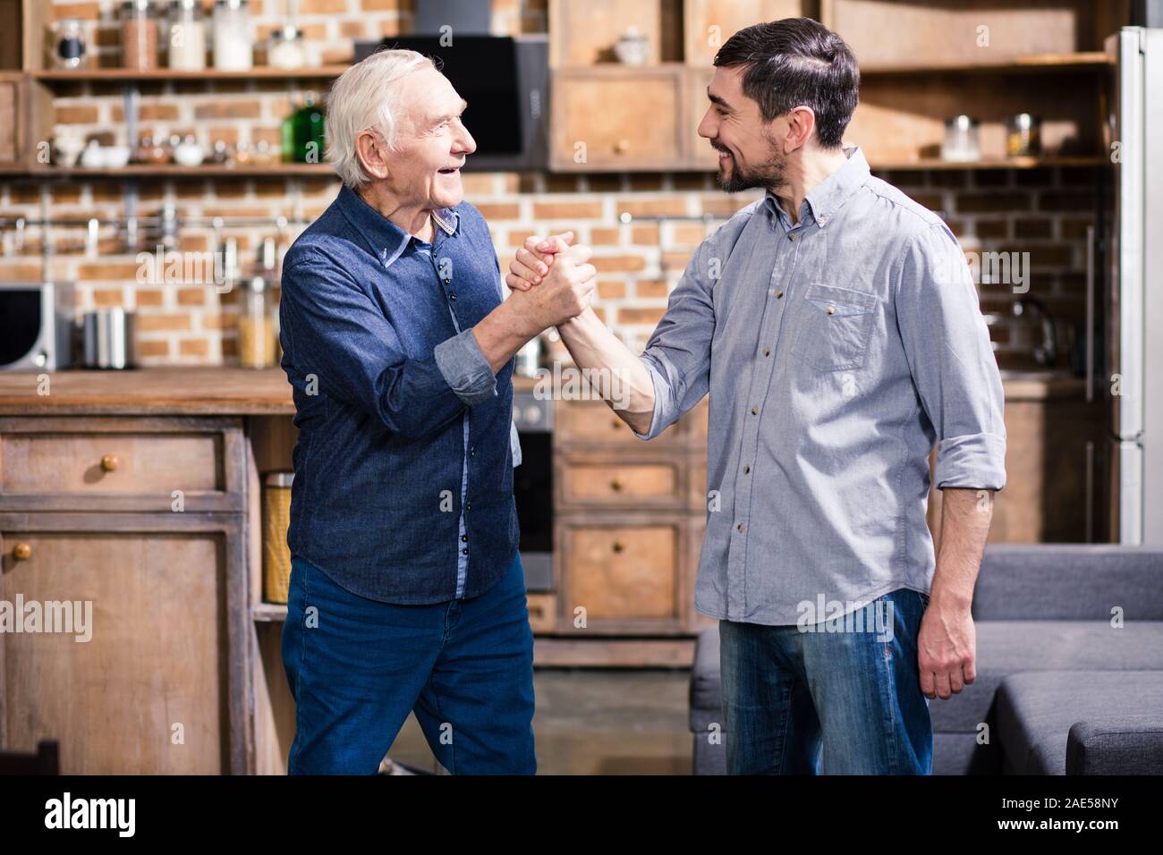 Positive aged father resting with his son Stock Photo