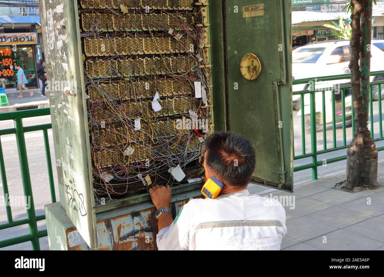 Bangkok, Thailand December 4, 2019 A technician sitting on sidewalk