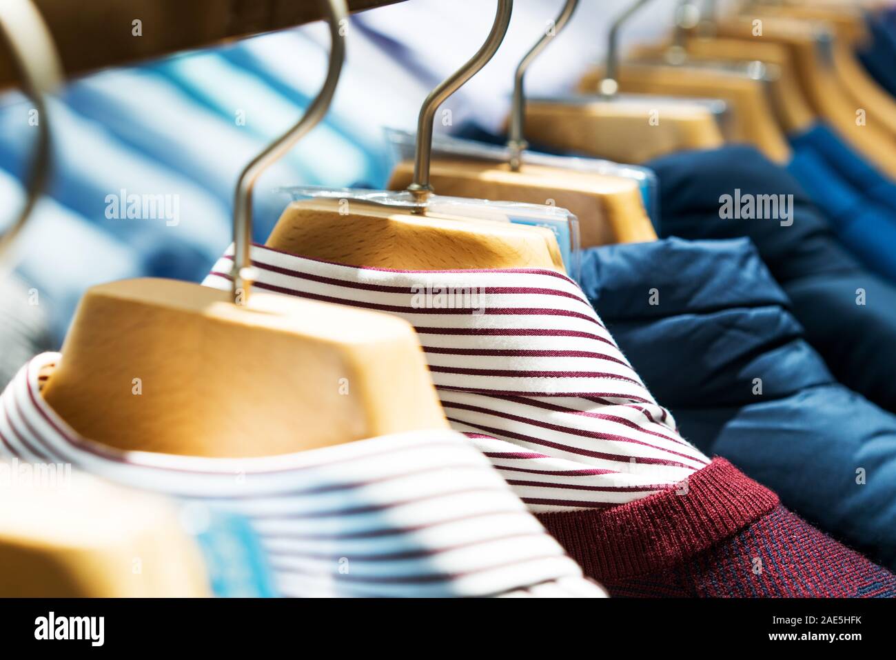 Selective focus winter coats hanged on a clothes rack. Stock Photo