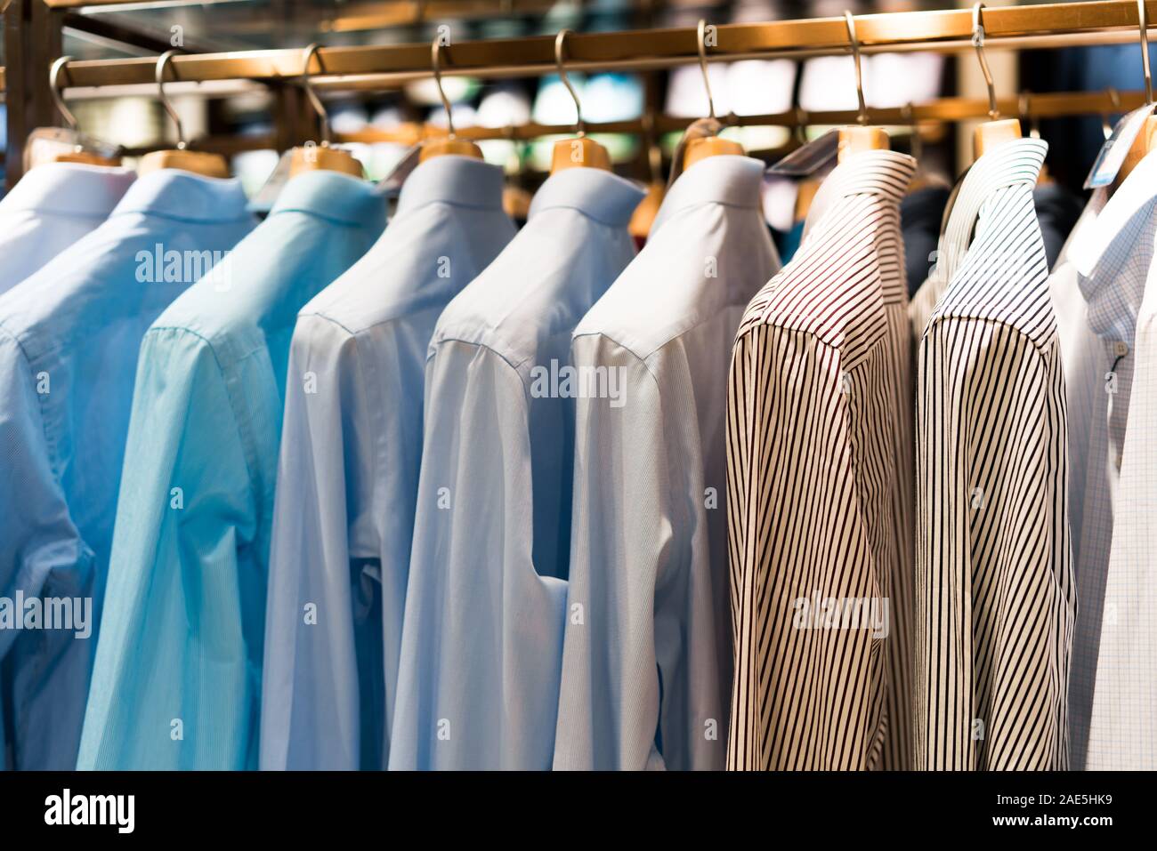 Men suits hanging in a clothing store. Stock Photo