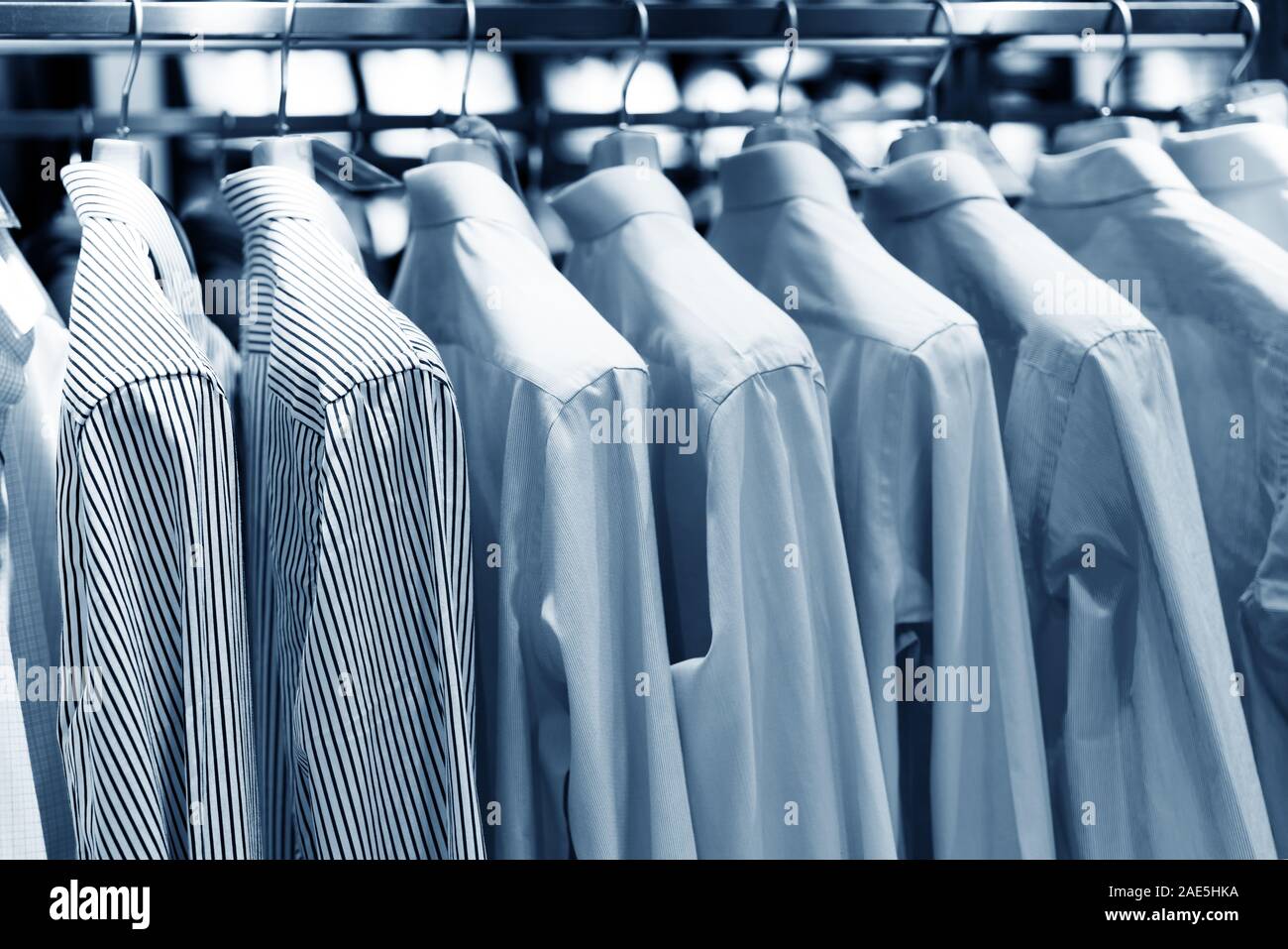 Men suits hanging in a clothing store. Stock Photo