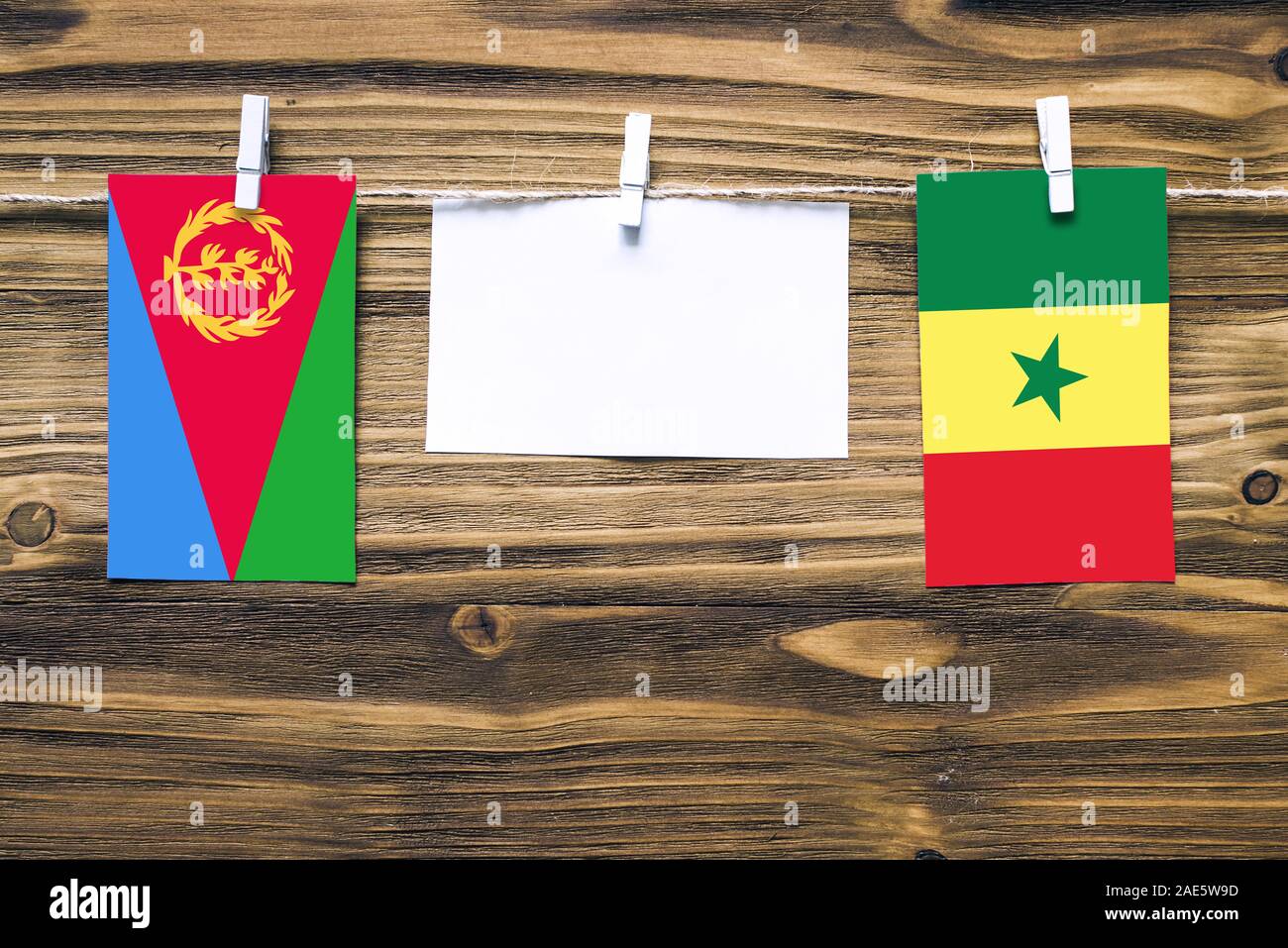 Hanging flags of Eritrea and Senegal attached to rope with clothes pins ...