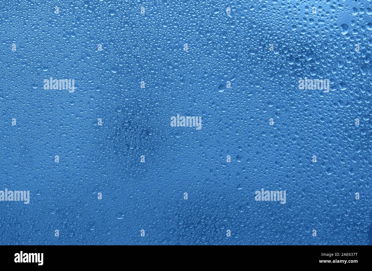 Window with water drops. Blue colored background Stock Photo Alamy